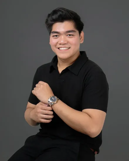 Agil Al Idrus, smiling, in a black polo shirt